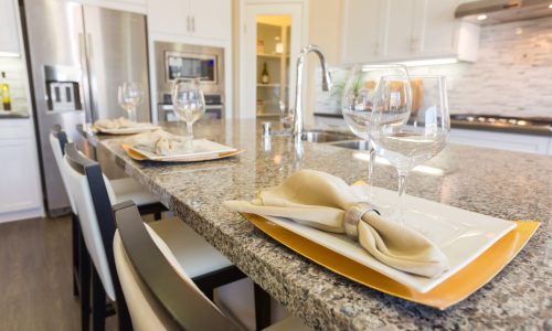 Abstract of Beautiful Kitchen Granite Counter Place Settings and Chairs.