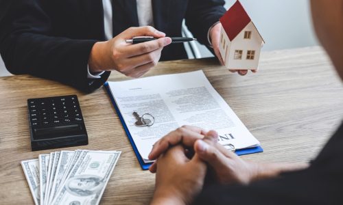 Estate agent broker reach contract form and presentation to client signing agreement contract real estate with approved mortgage application form, buying mortgage loan offer for and house insurance.