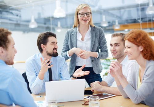 Group of business partners discussing ideas at meeting in office