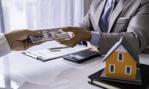 Paying for a Home with a Real Estate Agent, business man paying money to buy or deposit the house to a realtor or real estate agent