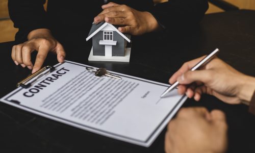 Real estate agent or sales manager has proposed terms and conditions to customers who sign house purchase agreements with insurance, Agreement to sign the purchase contract concept.